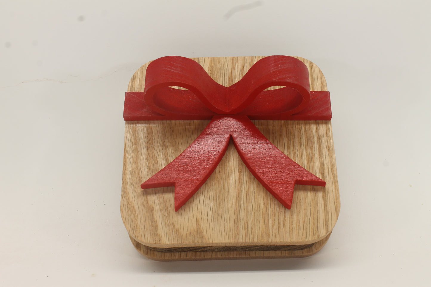 Wooden gift box with red wooden bow