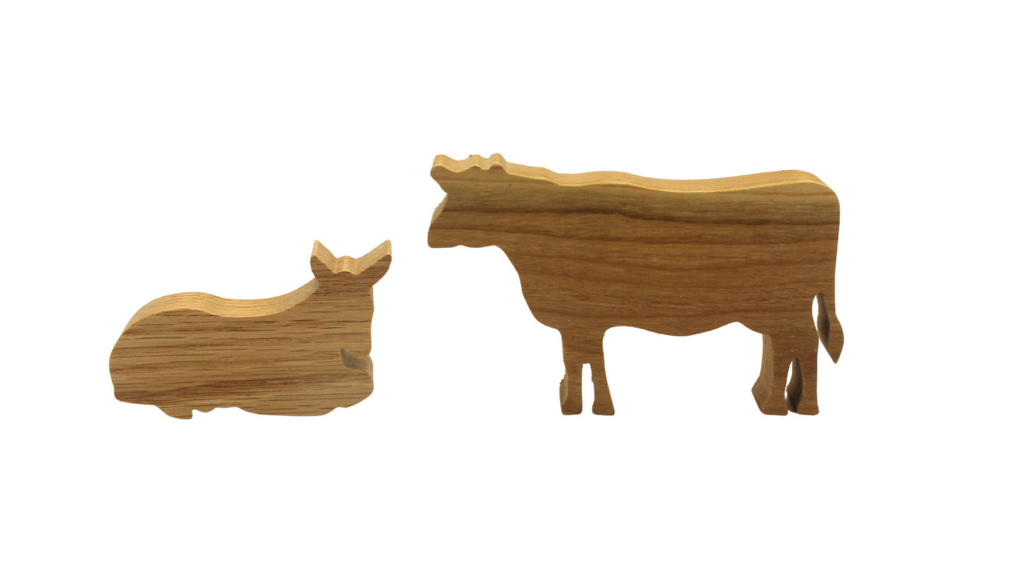Multi-piece wood nativity with stable and figures, town of Bethlehem in the background