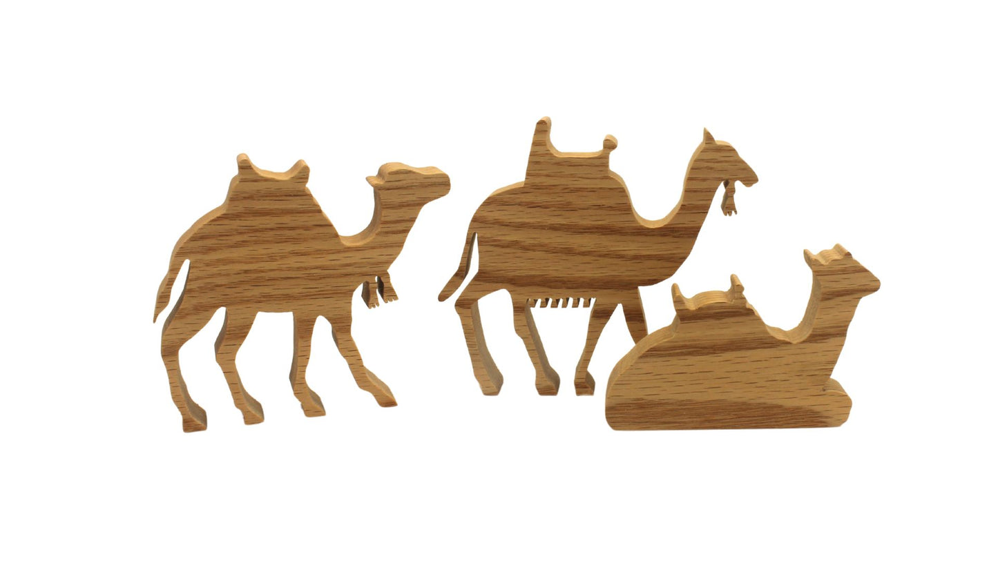 Multi-piece wood nativity with stable and figures, town of Bethlehem in the background