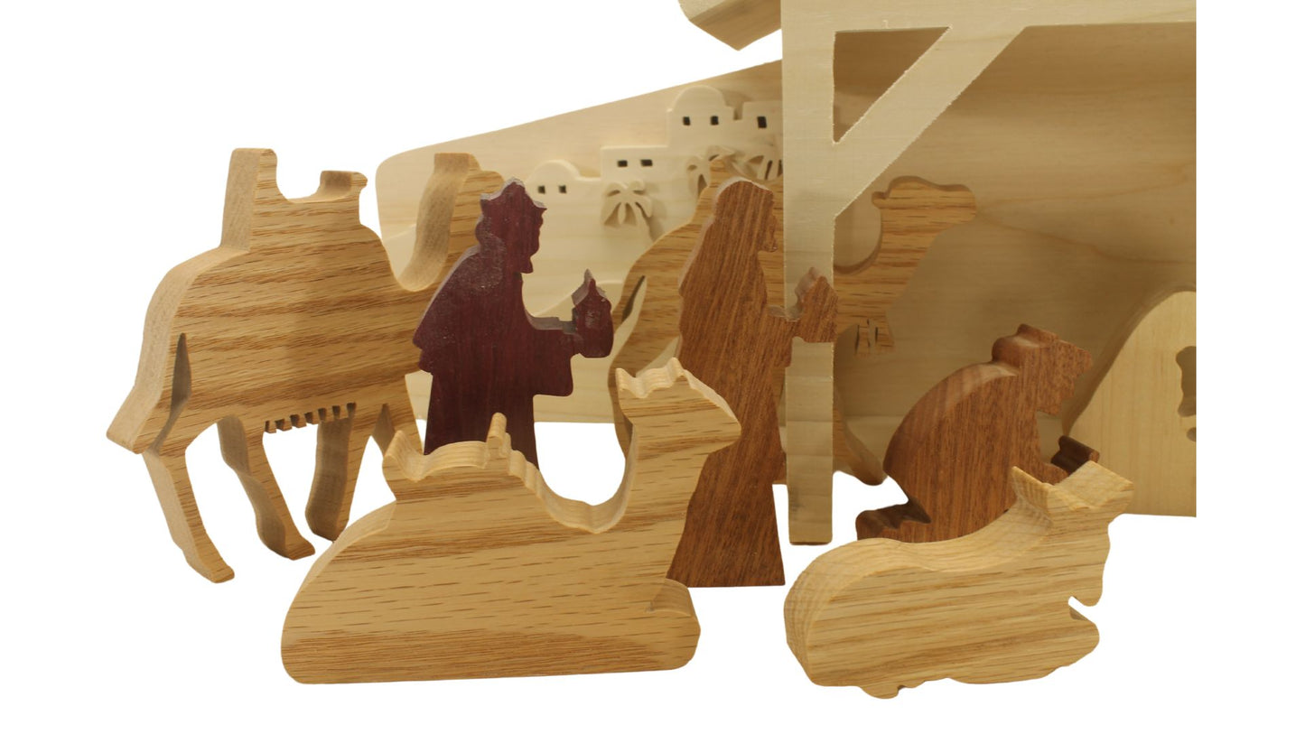 Multi-piece wood nativity with stable and figures, town of Bethlehem in the background