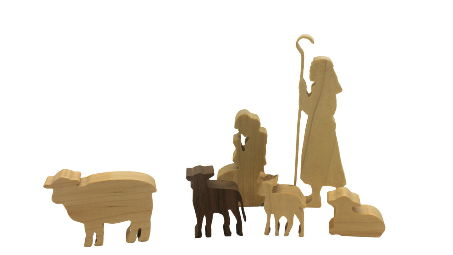 Multi-piece wood nativity with stable and figures, town of Bethlehem in the background