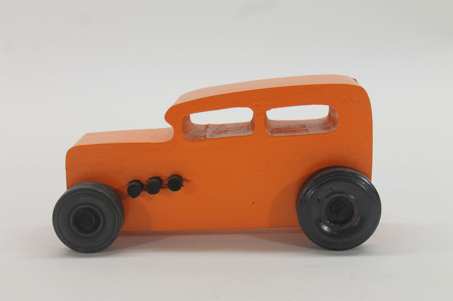 Wooden toy Ford hot rod set, 3 cars, painted yellow, red, and orange with black tires.