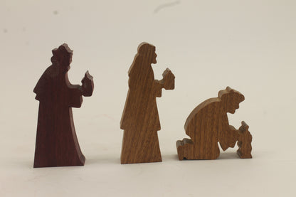 Multi-piece wood nativity with stable and figures, town of Bethlehem in the background