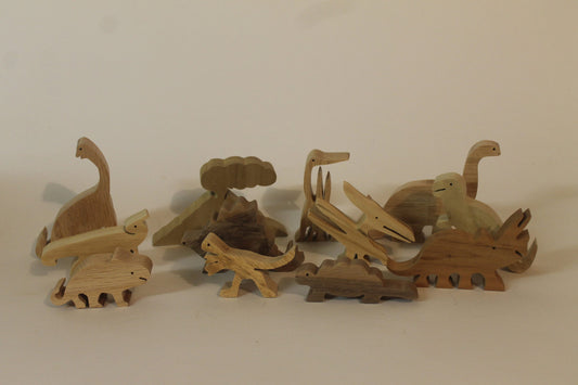 Dinosaur set made from hardwoods such as oak, walnut, poplar. Includes a volcano. Child safe oil finish