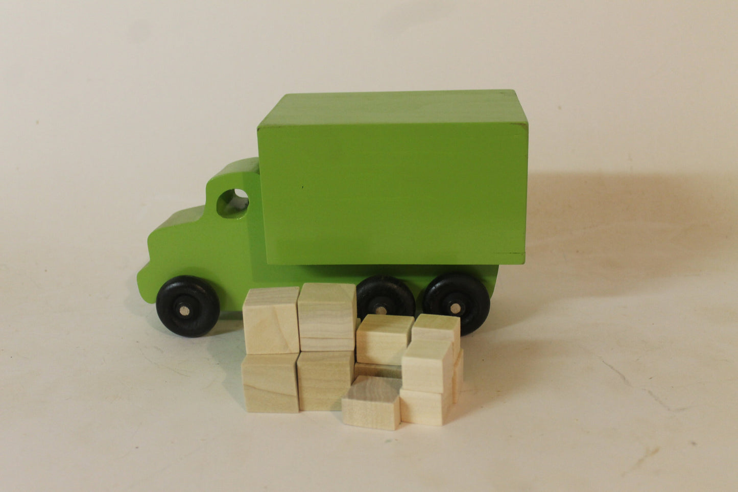 Moving or parcel truck for kids who love to play with toys on wheels. Solid poplar, wooden packages included, choice of color for the truck