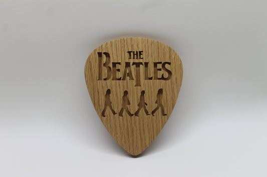 Beatles crossing Abbey Road on giant guitar pick shape, choice of oak or cherry. Decoration only, cannot be used as an actual guitar pick