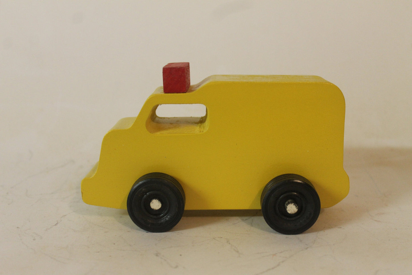 Handmade toy wooden vehicles. The set includes a tank truck, police car, ambulance, and  fire truck. Handmade from solid wood and brightly painted