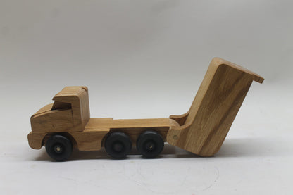 Toy wooden dump truck. What toy truck is more fun for kids than a dump truck? This tilting bed truck comes in oak or a choice of colors