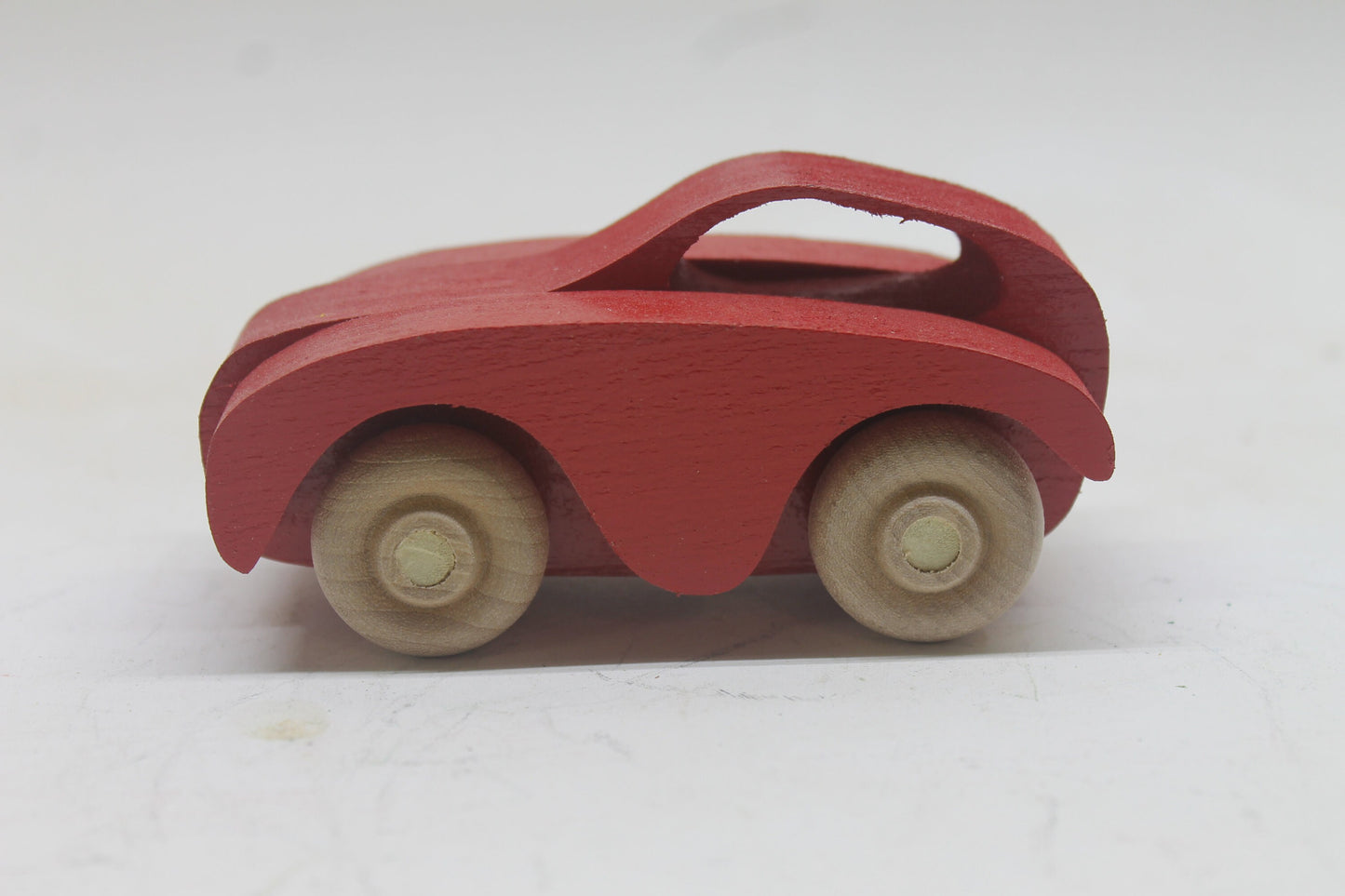 Toy car carrier, all handcrafted solid wood.  Has a tractor and trailer with loading ramp, three cars, and a pickup truck