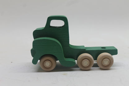 Toy car carrier, all handcrafted solid wood.  Has a tractor and trailer with loading ramp, three cars, and a pickup truck